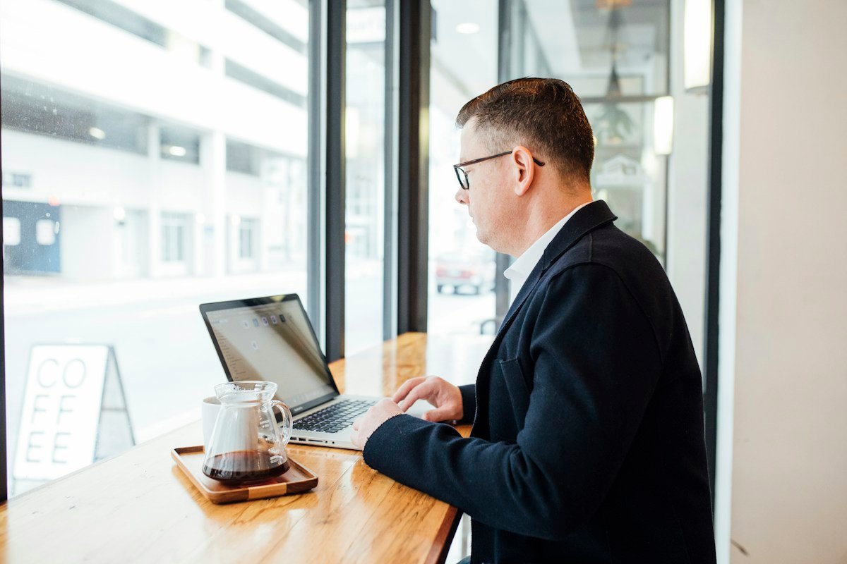 Professional reviewing plans on a laptop